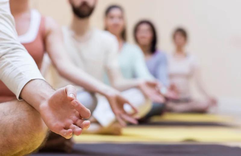 A group meditating together in a karma healing session